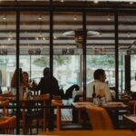 A bustling restaurant interior showcasing diners enjoying their meals in a cozy atmosphere.